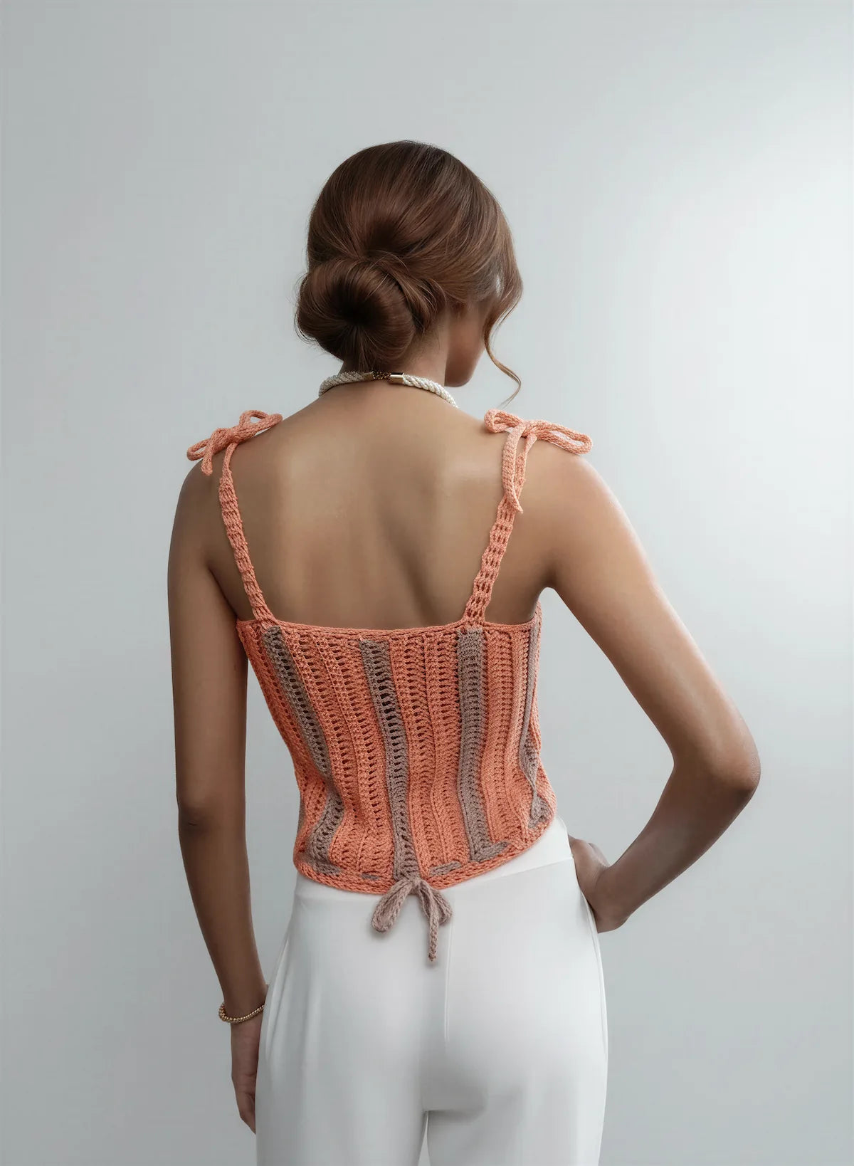 Haut Nakura – vue de dos chignon – haut crochet corail rayures bicolore gris bretelles nœuds lcet central dos – Cachalabibi 