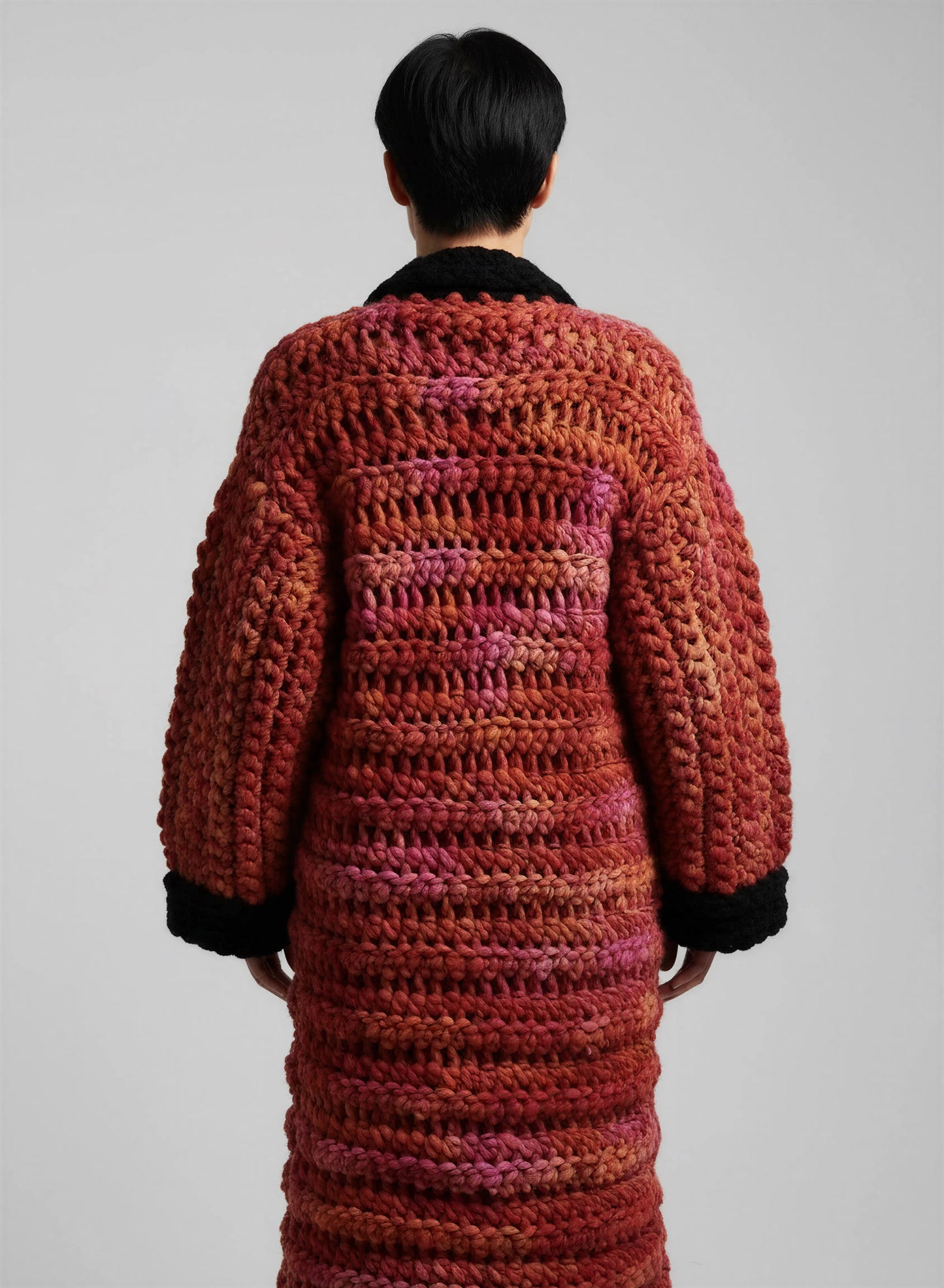 Manteau crochet fait main Kozakine rouge orange chiné grosse maille maxi dos manchettes noires festonnées – de dos - Cachalabibi